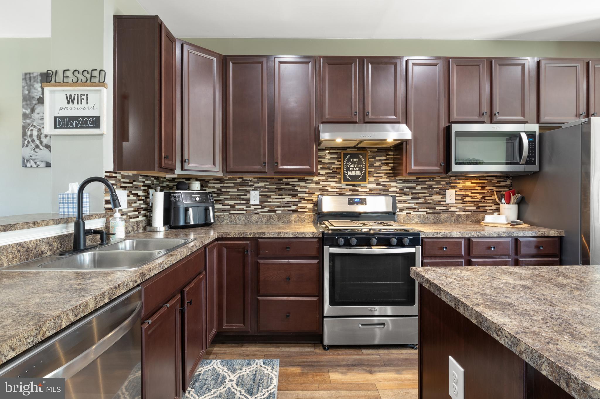 855 Blossom Drive Hanover, PA 17331 - Photo 18 of 53 a kitchen with stainless steel appliances granite countertop a stove microwave and sink