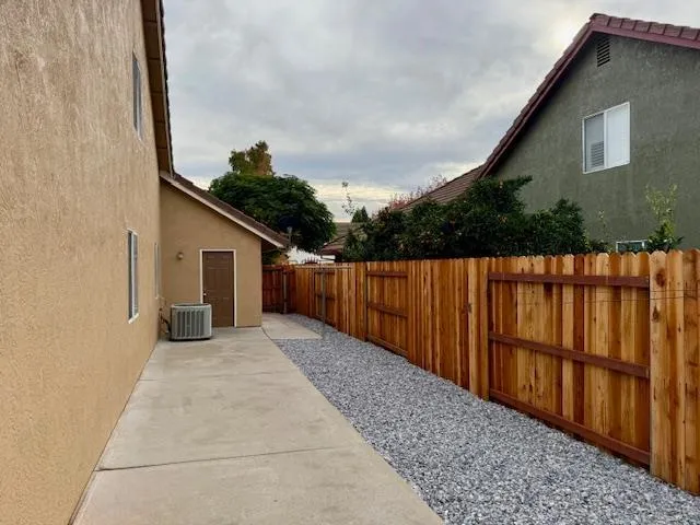 a view of a house with wooden fence