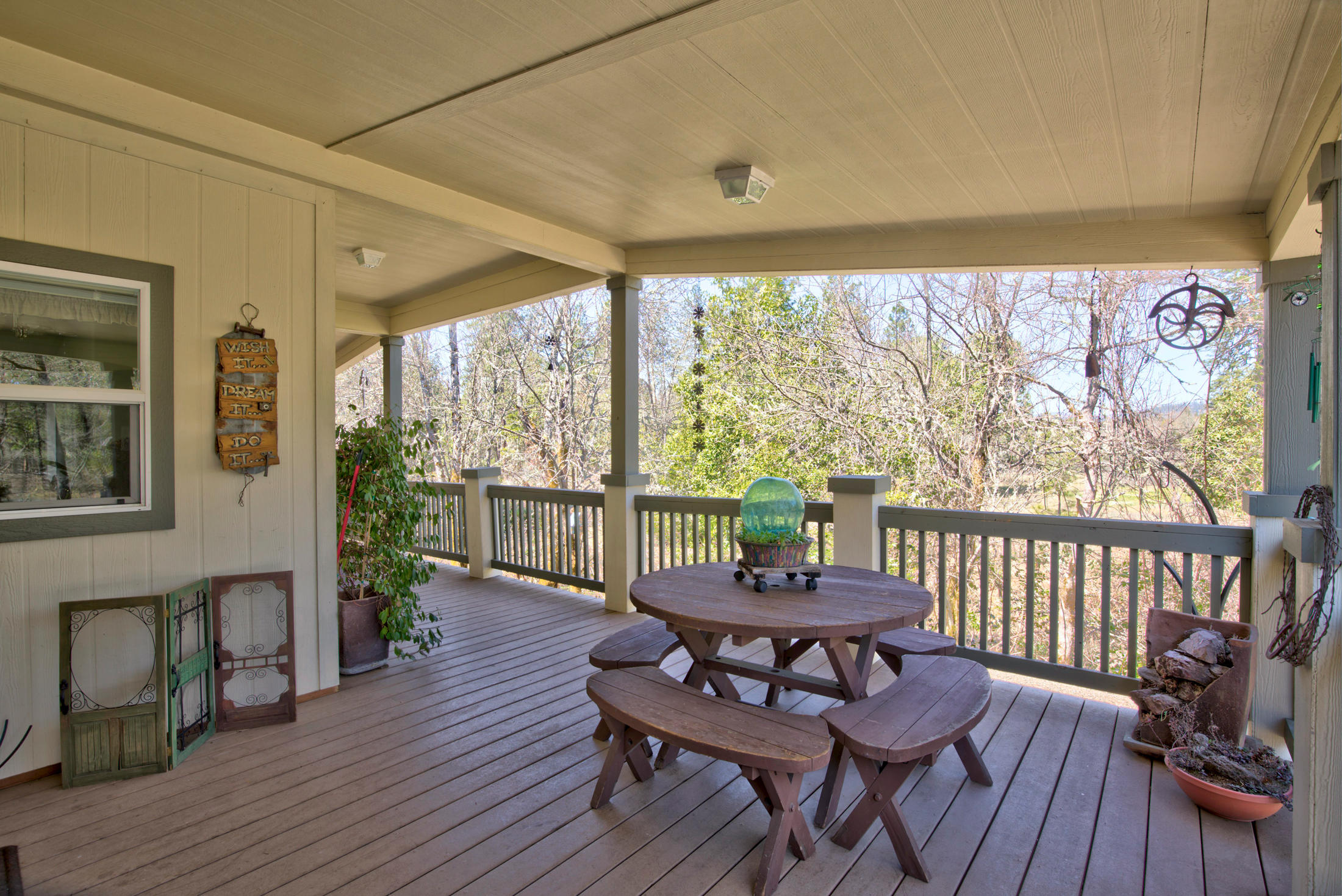 4550 Holland Loop Road Cave Junction, OR 97523 - Photo 24 of 39 a view of a porch with furniture and wooden floor