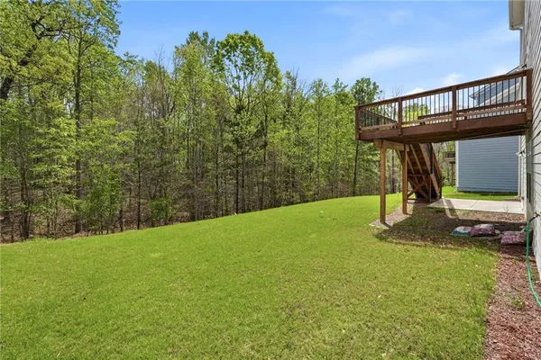 a roof deck with couches and wooden floor
