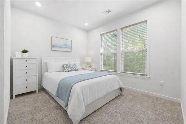 a bedroom with a bed and a potted plant