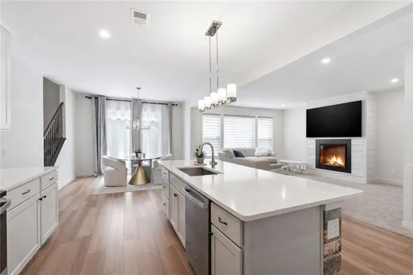 a kitchen with stainless steel appliances a sink stove and cabinets