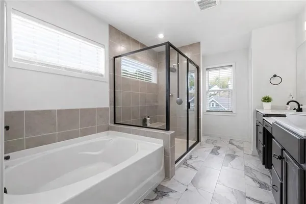 a bathroom with a sink vanity toilet and shower