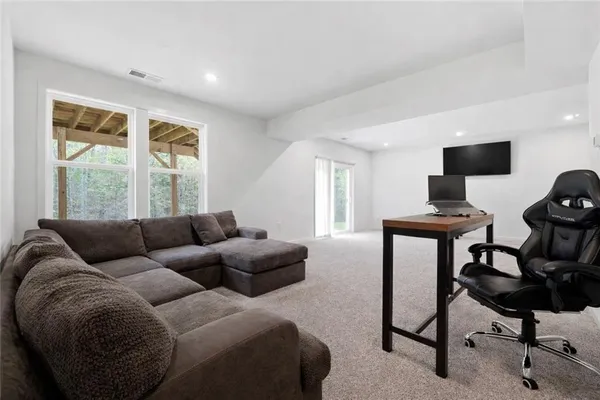 a living room with furniture and a potted plant