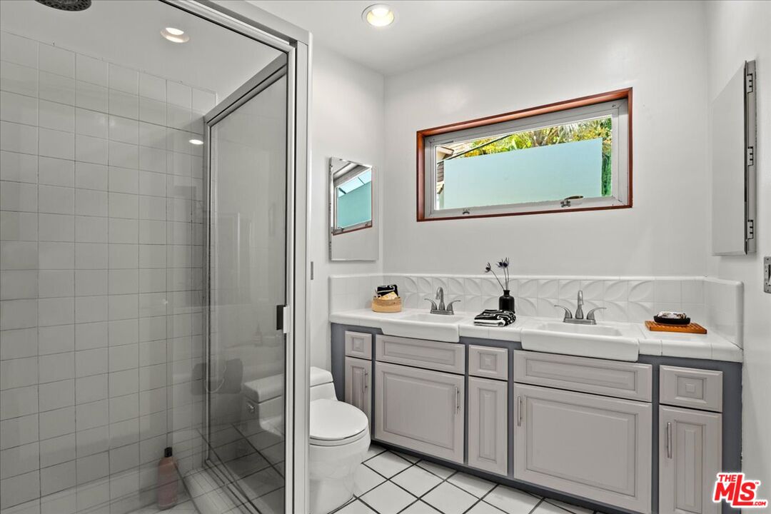 3234 Hillock Drive Los Angeles, CA 90068 - Photo 18 of 25 a bathroom with a toilet sink vanity and mirror