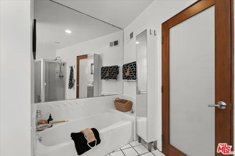 a bathroom with a bathtub and a shower