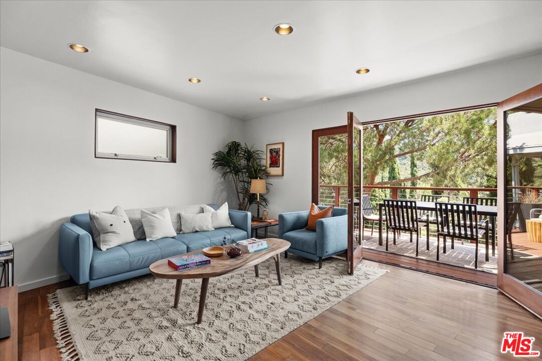 3234 Hillock Drive Los Angeles, CA 90068 - Photo 2 of 25 a living room with furniture a rug and a large window