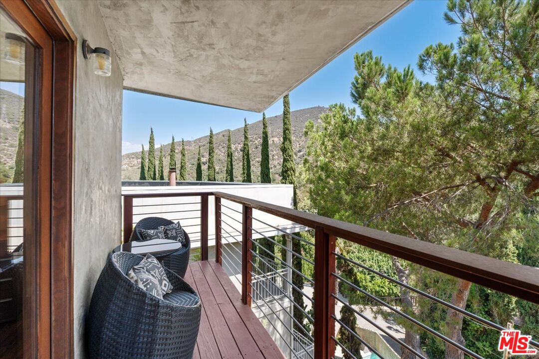 3234 Hillock Drive Los Angeles, CA 90068 - Photo 23 of 25 a view of a balcony with couches and wooden floor