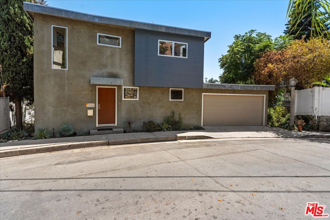 3234 Hillock Drive Los Angeles, CA 90068 - Photo 24 of 25 a front view of a house with garage and plants