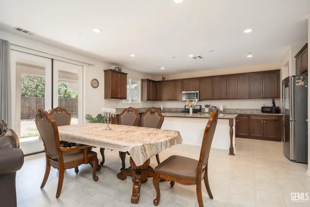 a view of a dining room with furniture and a kitchen