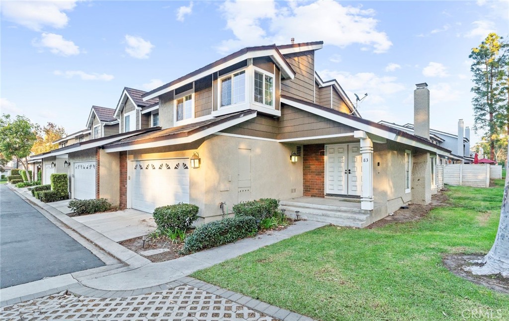 83 Weepingwood, Unit 35 Irvine, CA 92614 - Photo 1 of 19 a front view of a house with garden