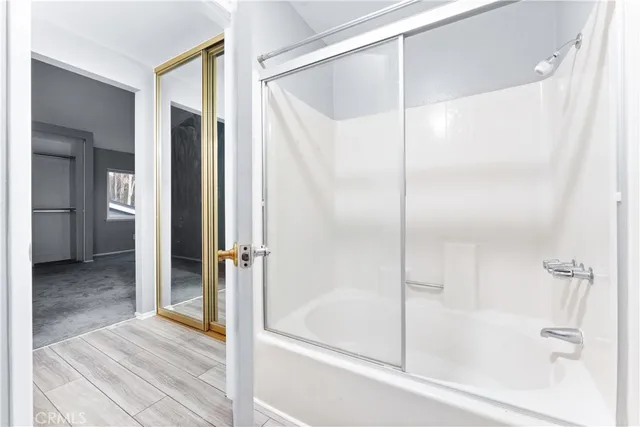 a bathroom with a shower and a bath tub