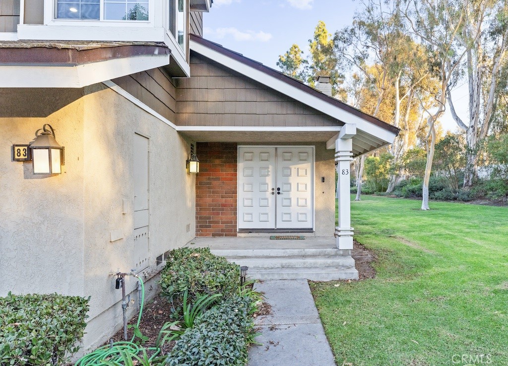 83 Weepingwood, Unit 35 Irvine, CA 92614 - Photo 18 of 19 a front view of a house with garden