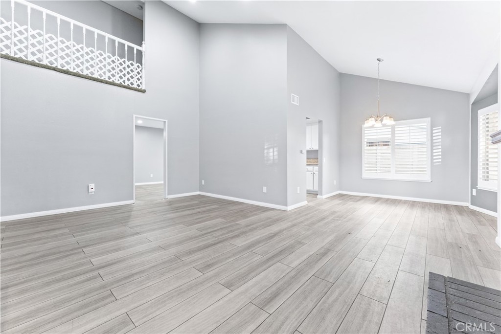 83 Weepingwood, Unit 35 Irvine, CA 92614 - Photo 3 of 19 wooden floor in an empty room with a window