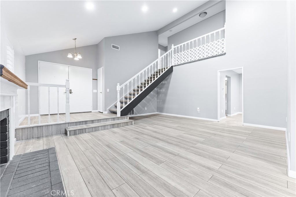 83 Weepingwood, Unit 35 Irvine, CA 92614 - Photo 4 of 19 a view of an entryway with wooden floor