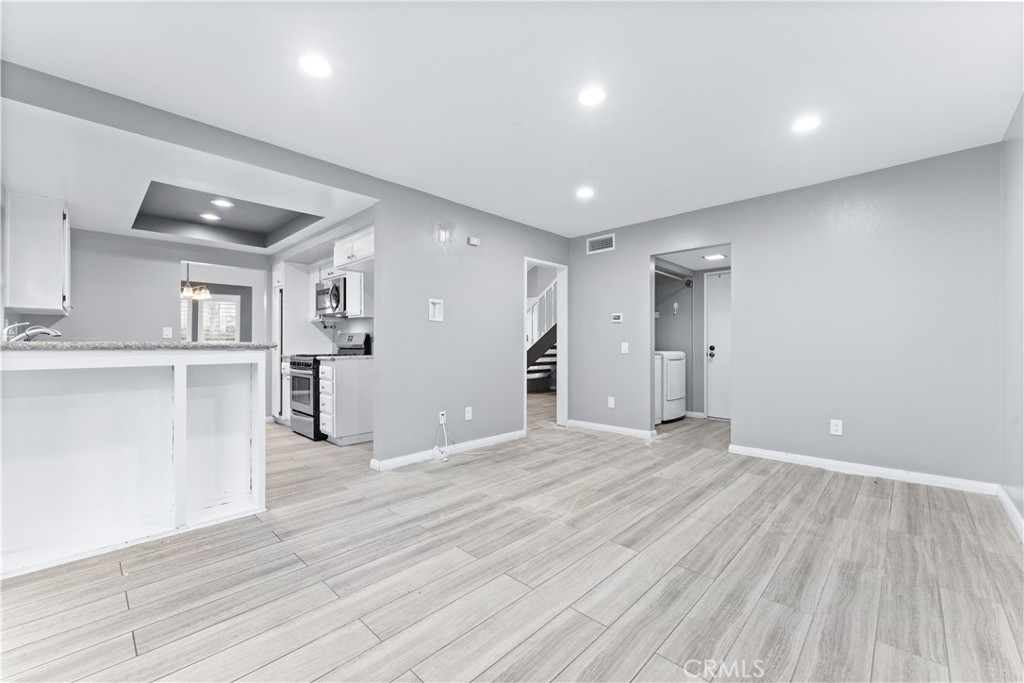 83 Weepingwood, Unit 35 Irvine, CA 92614 - Photo 7 of 19 a view of a kitchen with wooden floor and a window