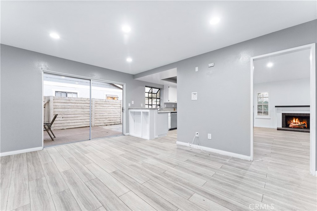 83 Weepingwood, Unit 35 Irvine, CA 92614 - Photo 8 of 19 a view of empty room with wooden floor and fireplace