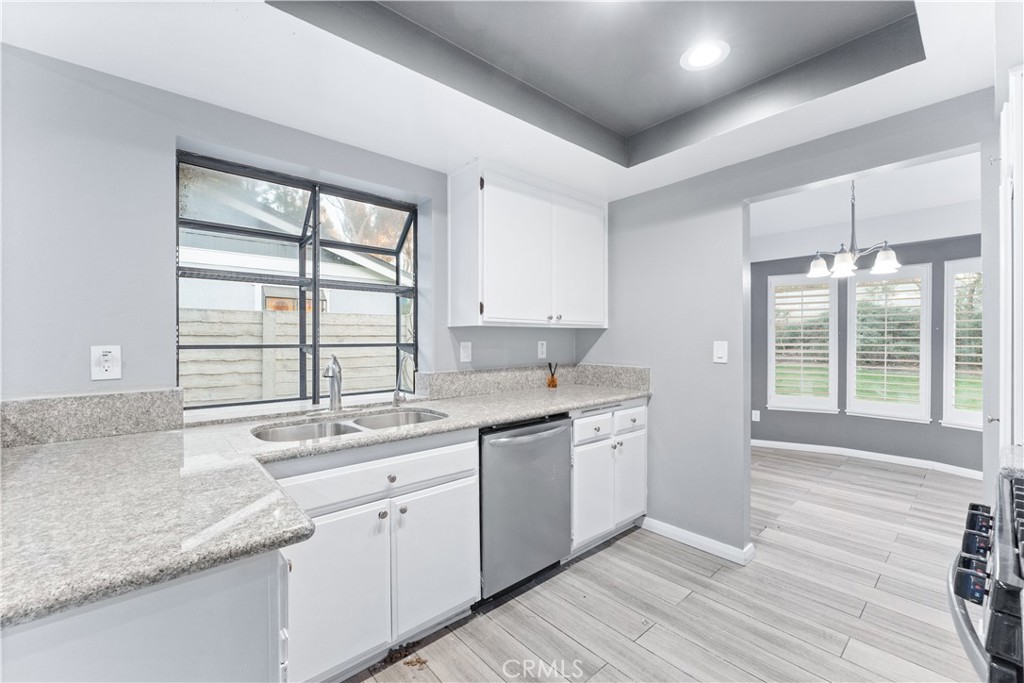83 Weepingwood, Unit 35 Irvine, CA 92614 - Photo 10 of 19 a kitchen with a sink stove and cabinets