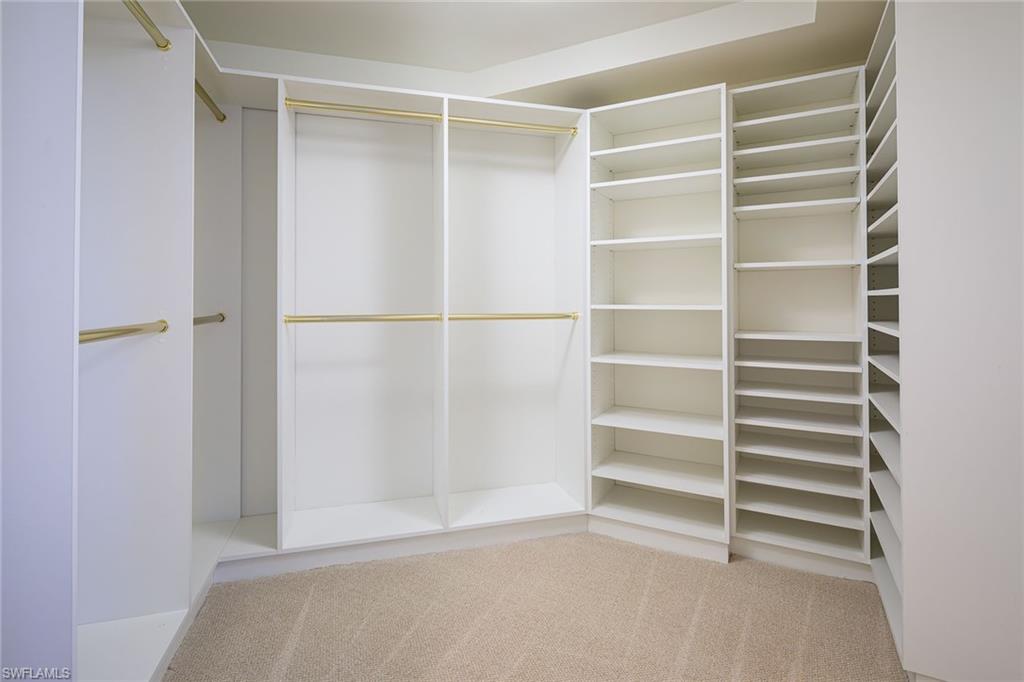 435 Dockside Drive, Unit B703 Naples, FL 34110 - Photo 20 of 38 a view of walk in closet with empty racks