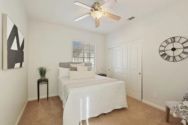 a bedroom with a bed and lamp