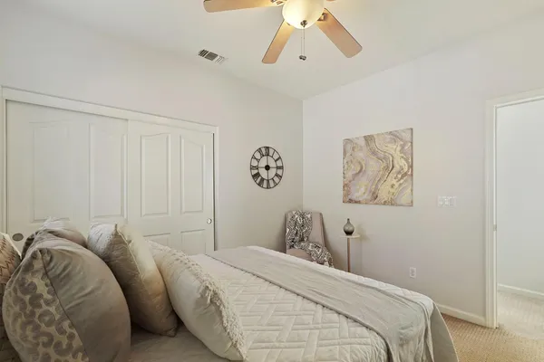 a bedroom with a bed and a dresser in it