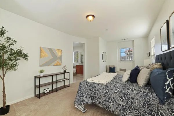 a bathroom with a granite countertop sink a mirror and a bathtub