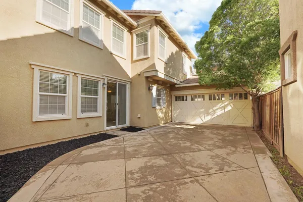 a kitchen with appliances a sink a counter top space and living room view