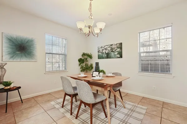 a large kitchen with granite countertop a sink white cabinets and a granite counter tops
