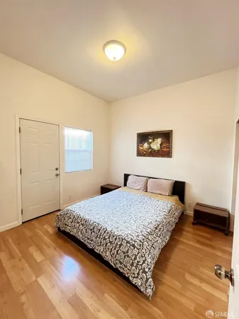 a bedroom with a bed and a night stand