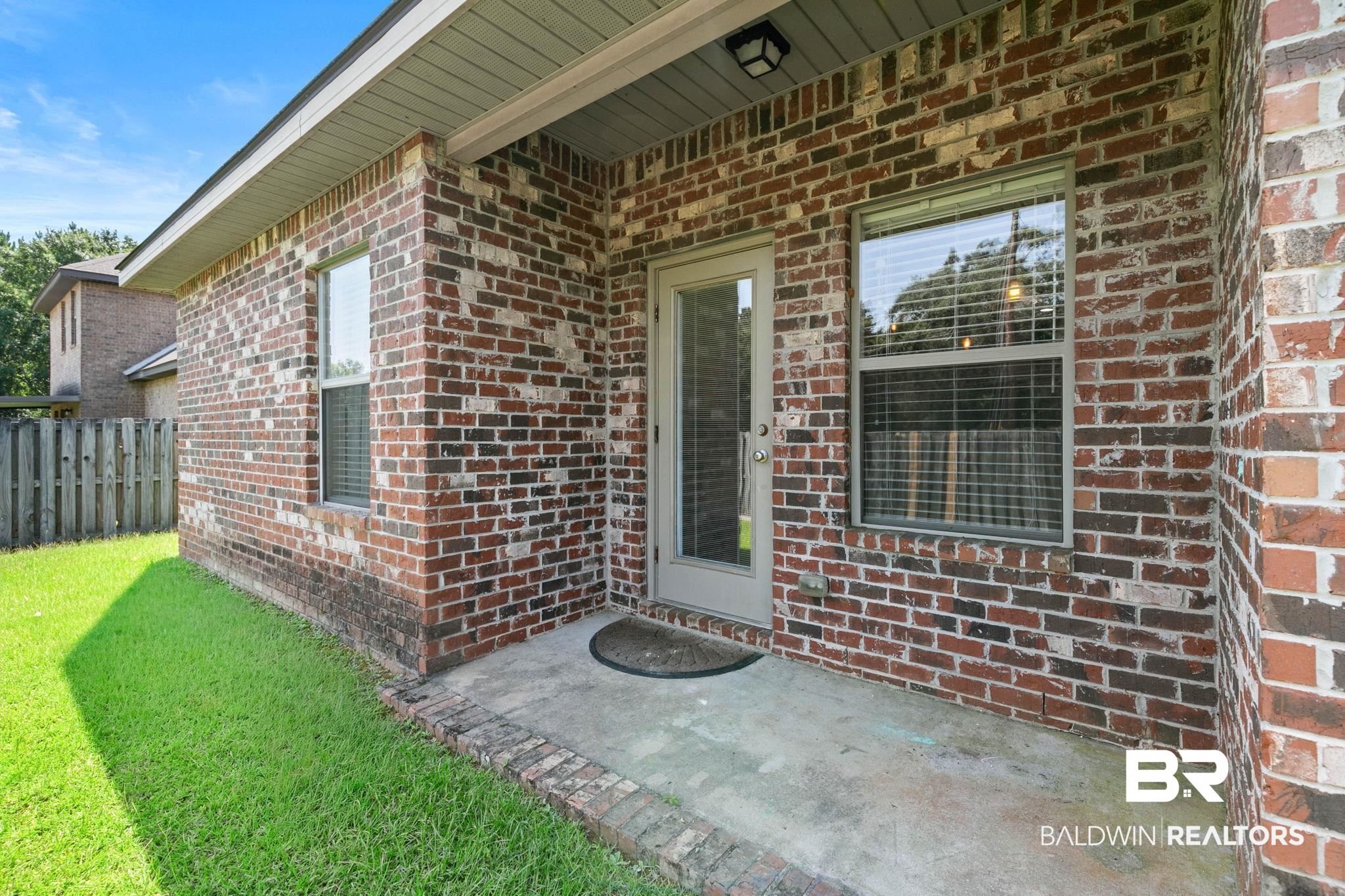 2216 Livingstone Court Mobile, AL 36695 - Photo 38 of 62 Brick exterior featuring multiple windows and a glass-paneled door