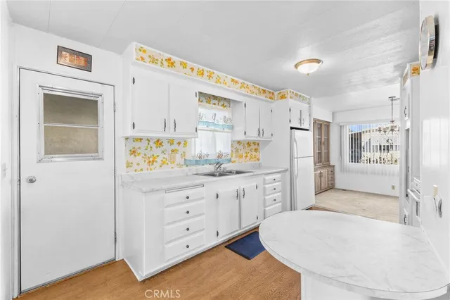 a spacious en suite bathroom with a granite countertop tub and a sink