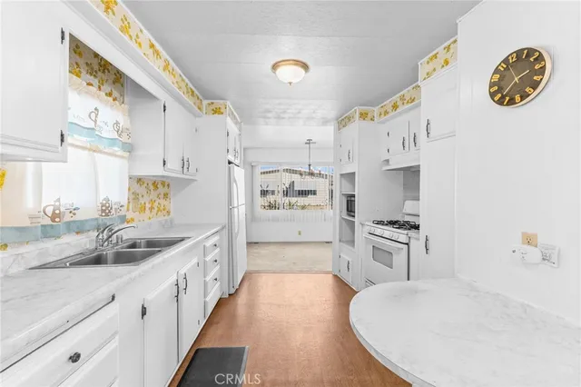 a kitchen with stainless steel appliances granite countertop a sink and a stove