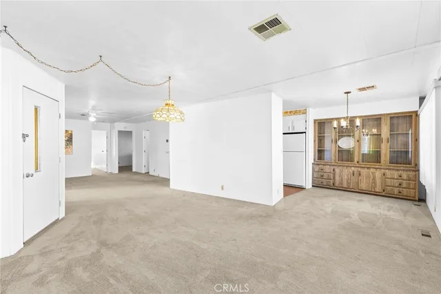 a view of a big room with closet and windows