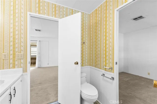 a bathroom with a toilet a sink and a shower