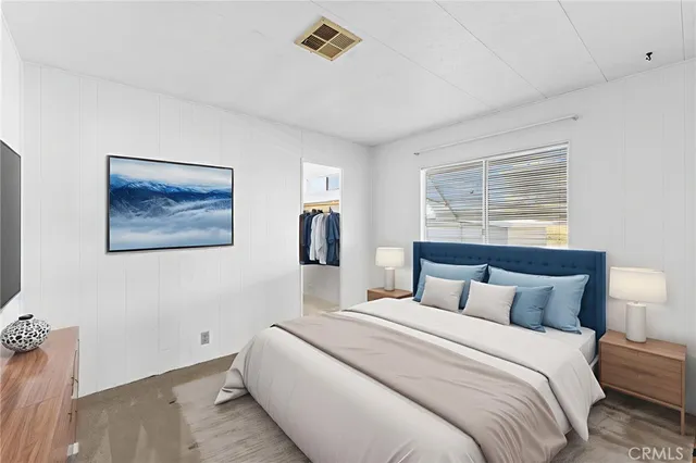 a bedroom with a large bed and a window