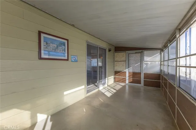a living room with lots of furniture and a large window