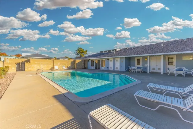 a view of a livingroom with furniture and floor to ceiling window