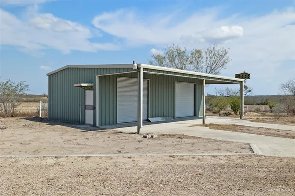 a view of a house with backyard porch and sitting area