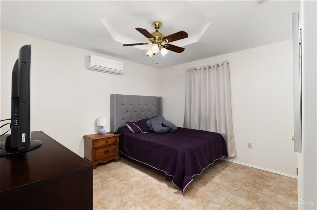 116 Margarito Street Roma, TX 78584 - Photo 8 of 29 a bedroom with a bed and a flat screen tv