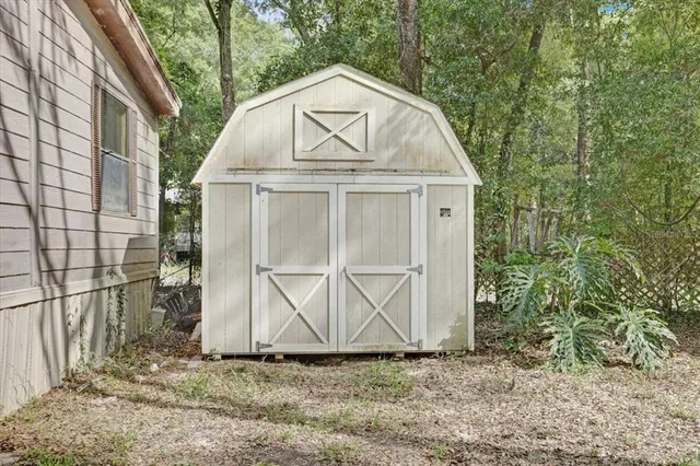 a view of a small house with a yard