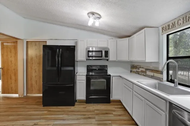 a kitchen with a refrigerator and a sink
