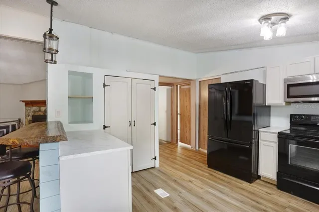 a kitchen with a refrigerator a stove and a sink