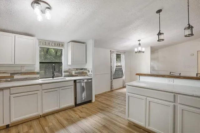 a kitchen with a sink cabinets and window
