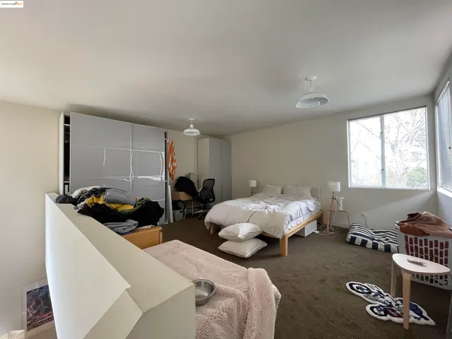 a bedroom with two beds and a couch