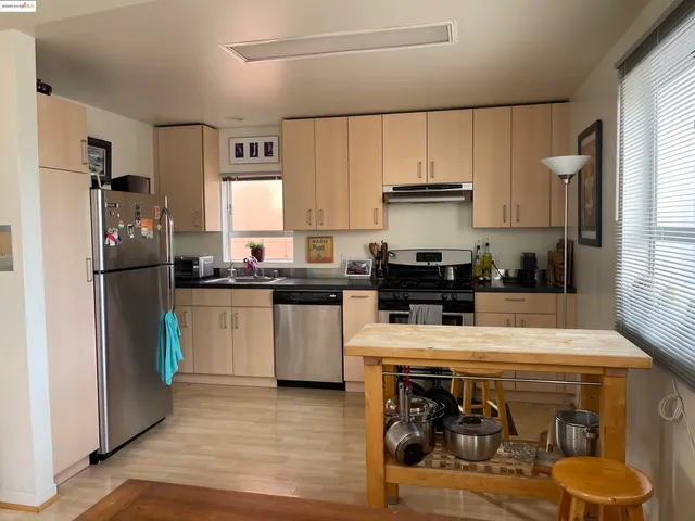 a kitchen with a refrigerator and a stove