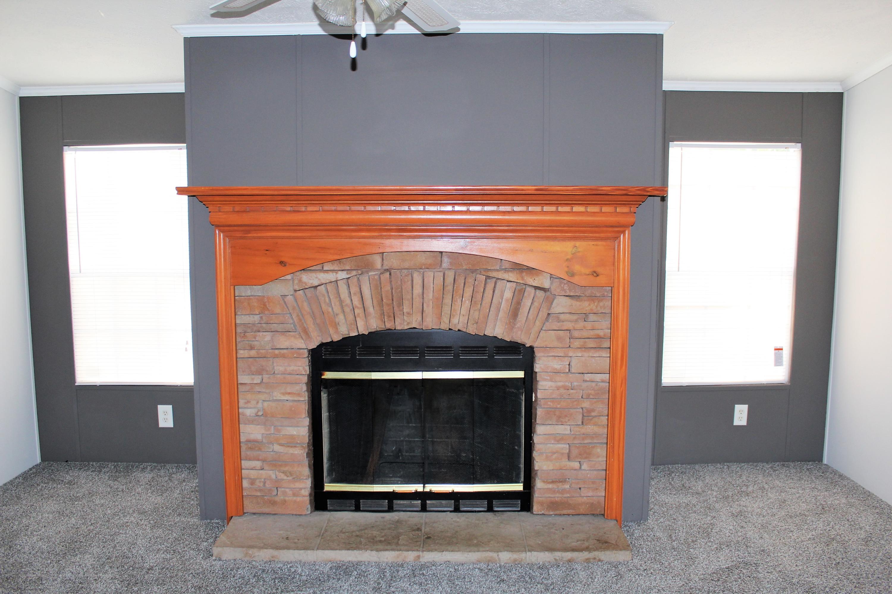 1140 Alex Brown Road Bonifay, FL 32425 - Photo 8 of 16 a fireplace with a hallway