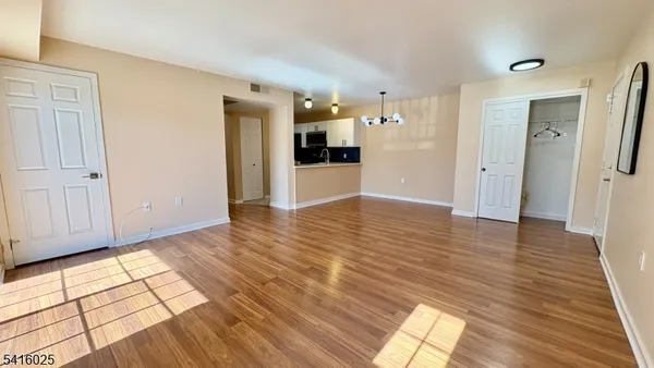 a view of a kitchen from the hallway with a sink