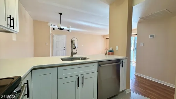 a kitchen with stainless steel appliances a refrigerator a sink a stove and cabinets