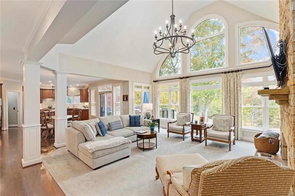 219 Morning Mist Way Woodstock, GA 30189 - Photo 15 of 72 a living room with furniture a chandelier and a large window