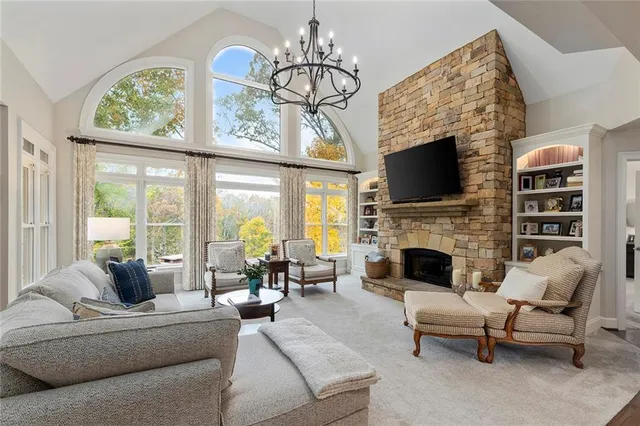 a living room with furniture a fireplace and a flat screen tv
